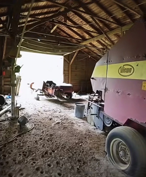 Farm equipment inside a historic barn